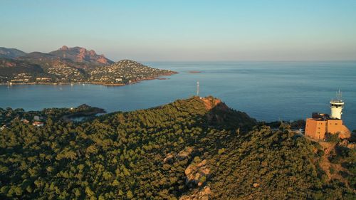 Scenic view of sea by buildings against sky