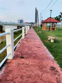 Footpath amidst buildings against sky