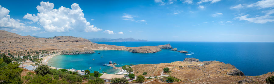 Panoramic view over local beach in an enclosed bay in lindos village. island of rhodes. greece.