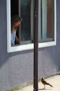 Side view of woman in glass window