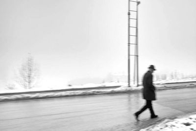 Woman standing on snow covered landscape