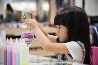Close-up of girl using mobile phone