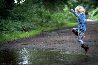 Side view of boy on tree