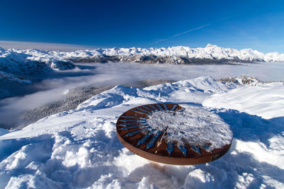 Snow covered mountain against blue sky