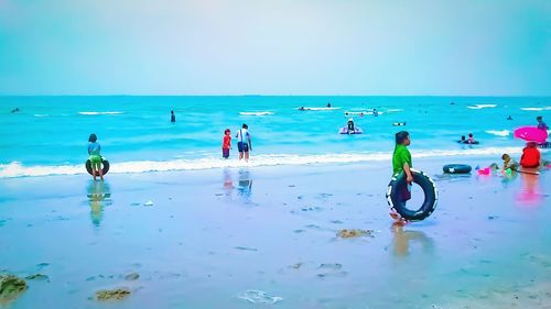 People on beach against sky