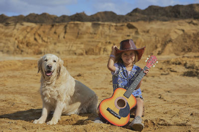 Side view of woman with dog on sand at beach