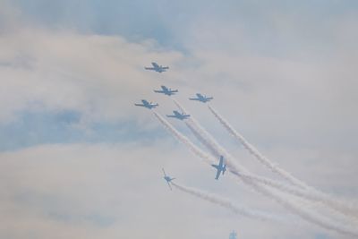 Low angle view of airshow against sky