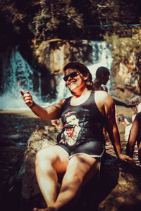 Young woman sitting on rock