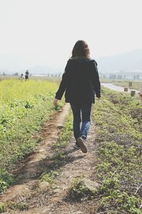 Full length of woman standing on grassy field