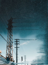 Low angle view of electricity pylon against sky