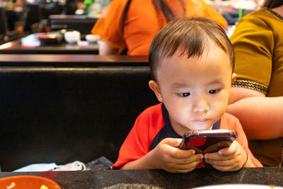 Portrait of boy holding mobile phone