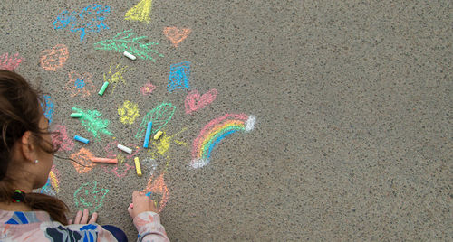 High angle view of girl playing with confetti on street