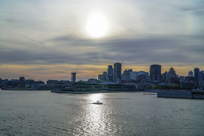 View of city at waterfront during sunset