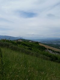 Scenic view of landscape against cloudy sky