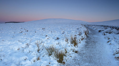 Scenic view of frozen lake against clear sky during winter