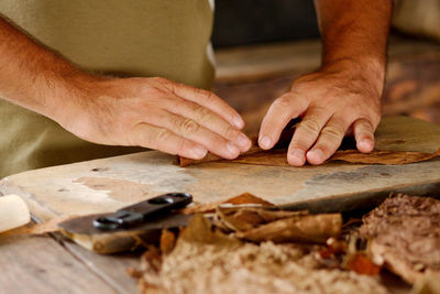 Midsection of man working on wood