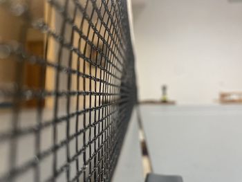 Close-up of barbed wire fence against sky