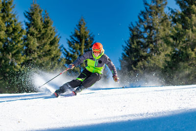 Full length woman skiing at ski resort