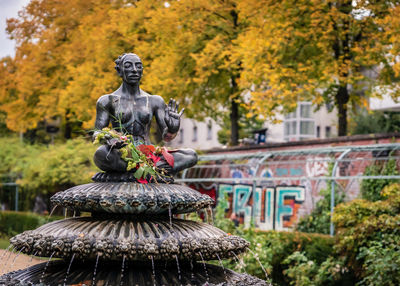 Statue of buddha against plants