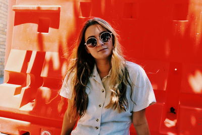 Portrait of young woman wearing sunglasses outdoors