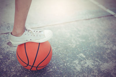 View of person with foot on basketball