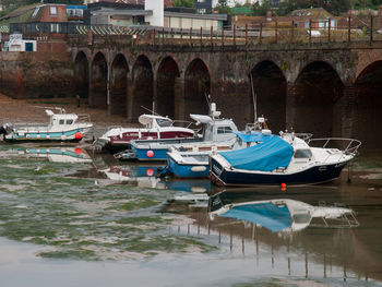 Boats moored in river