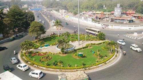High angle view of park amidst road on sunny day