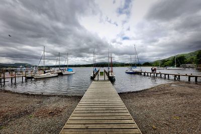 Pier on lake against sky