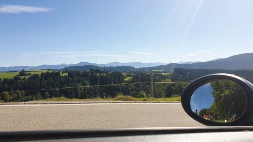 Scenic view of mountains against sky seen through car windshield