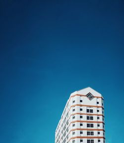 Low angle view of building against clear blue sky