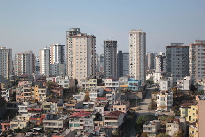 Buildings in city against clear sky