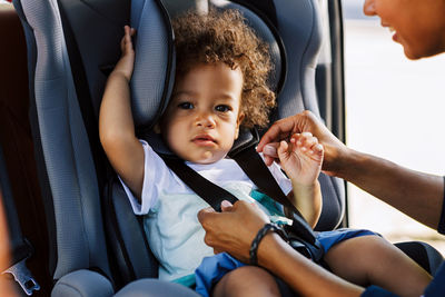 Portrait of cute baby girl sitting in car