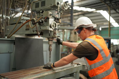 Side view of man working in factory