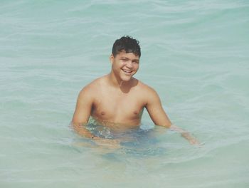 Portrait of smiling boy in sea