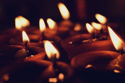 Close-up of burning diya in darkroom