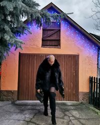 Full length of man standing against illuminated building