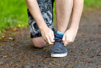 Low section of man running on footpath