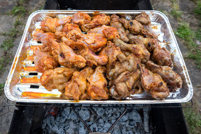 High angle view of meat on barbecue grill