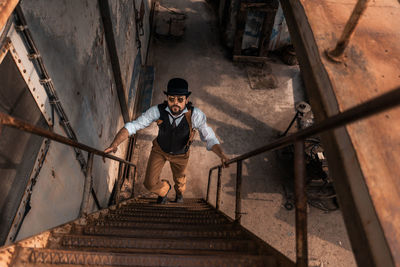 High angle view of man standing on staircase