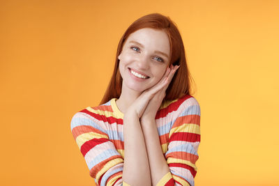 Smiling woman against yellow background