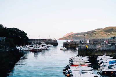 Boats moored at harbor