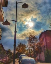 Street light against cloudy sky