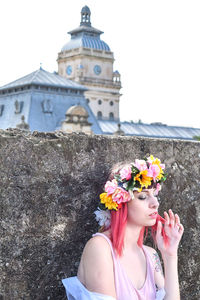 Low angle view of woman holding bouquet