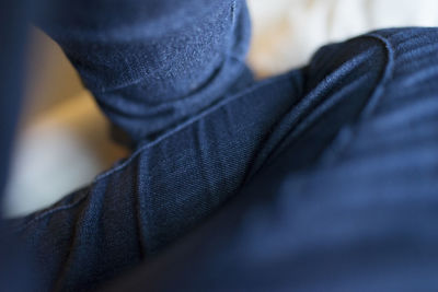 Cropped image of person wearing blue jeans