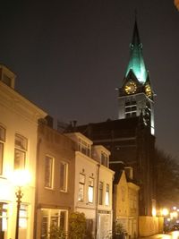 Low angle view of illuminated cathedral against sky at night