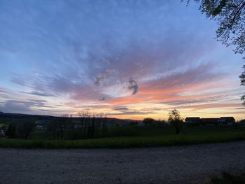 Scenic view of field against sky at sunset