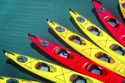 High angle view of multi colored boats moored in water