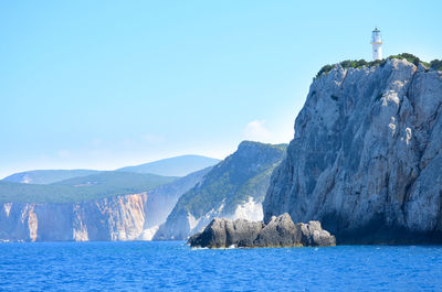 Boats in front of sea against blue sky