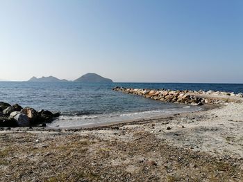 Scenic view of beach against clear sky