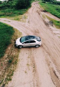 High angle view of car on dirt road